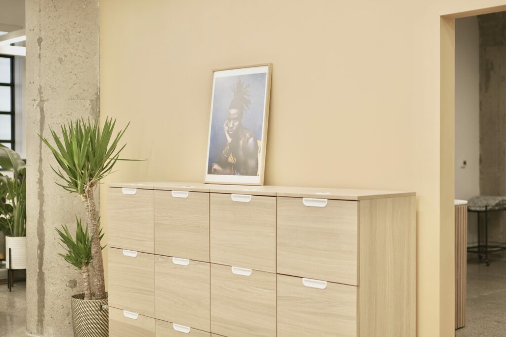 cupboards against a wall with an artwork of a person