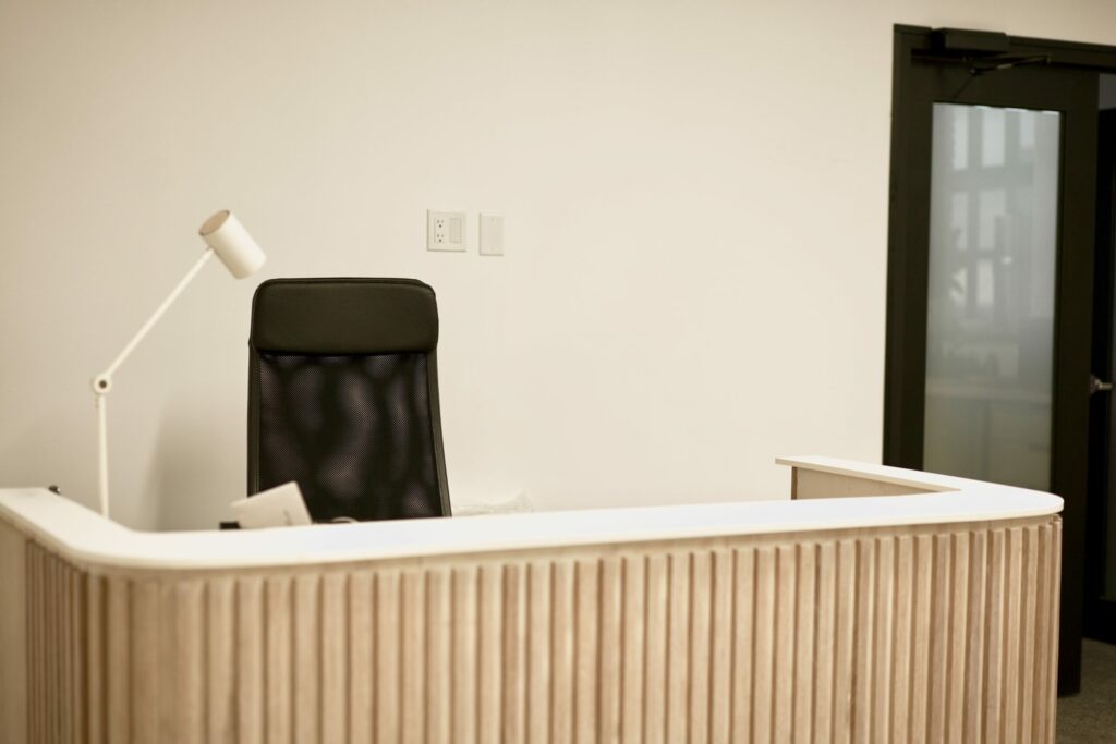 A reception desk with a empty chair