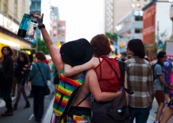 Two people with hands around each other shoulders