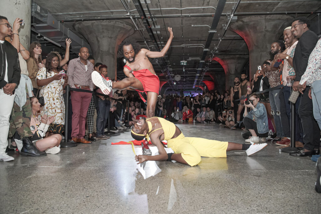 Two people dancing in a middle of a makeshift stage