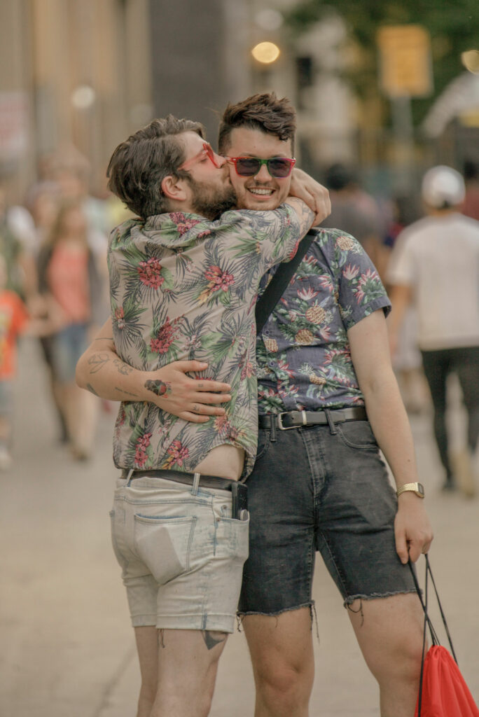 A person kissing another person on the cheek.