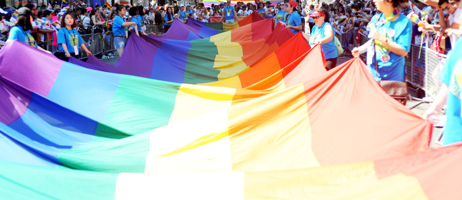 The Pride flag being walked through the parade.