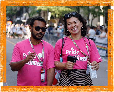 two volunteers smiling